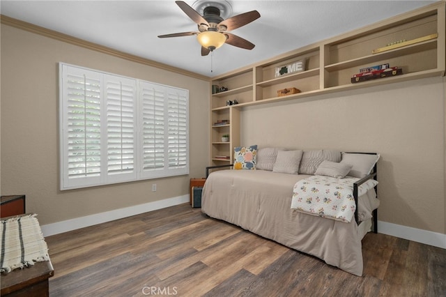 bedroom with ceiling fan, baseboards, wood finished floors, and crown molding