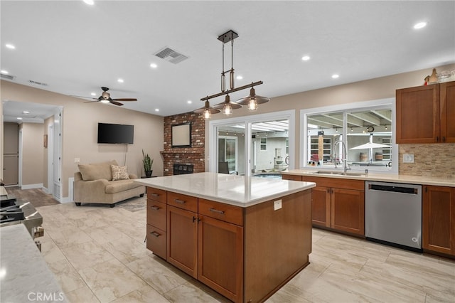 kitchen with dishwasher, a brick fireplace, visible vents, and a sink