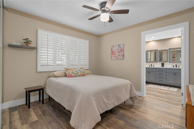 bedroom featuring ornamental molding, wood finished floors, baseboards, and a sink