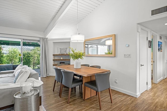 dining area with visible vents, vaulted ceiling with beams, baseboards, and wood finished floors