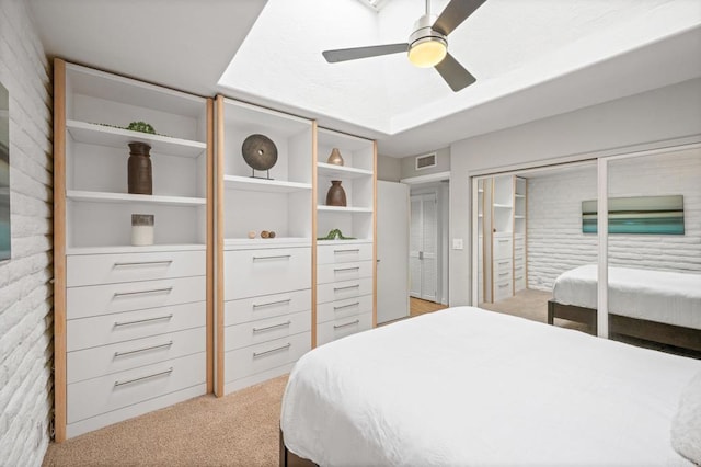 bedroom with light carpet, visible vents, a ceiling fan, and a closet