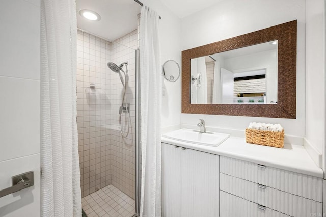 bathroom with a stall shower and vanity