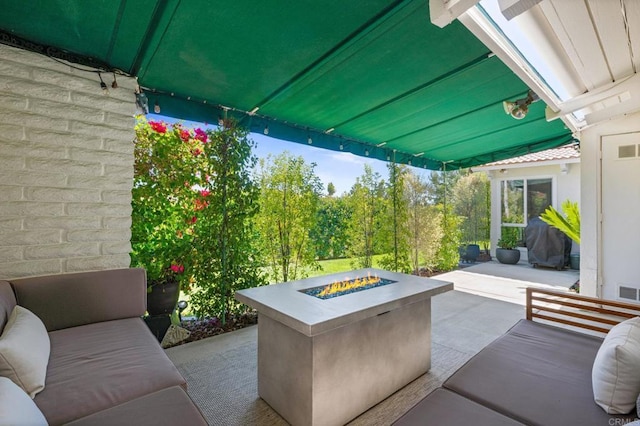 view of patio / terrace with an outdoor fire pit