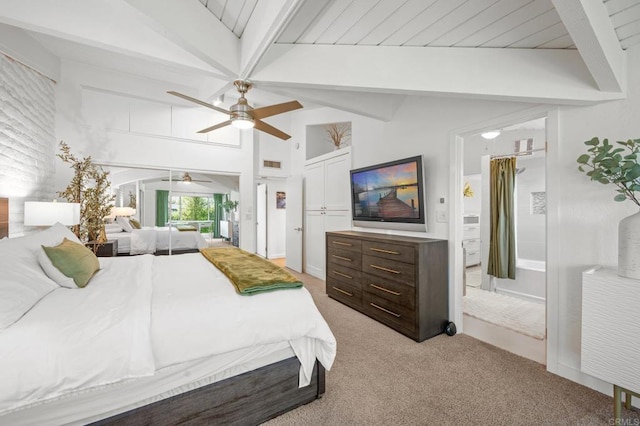 bedroom with light colored carpet, lofted ceiling with beams, and a ceiling fan