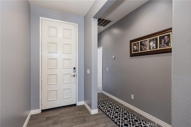 entrance foyer with visible vents, baseboards, and wood tiled floor