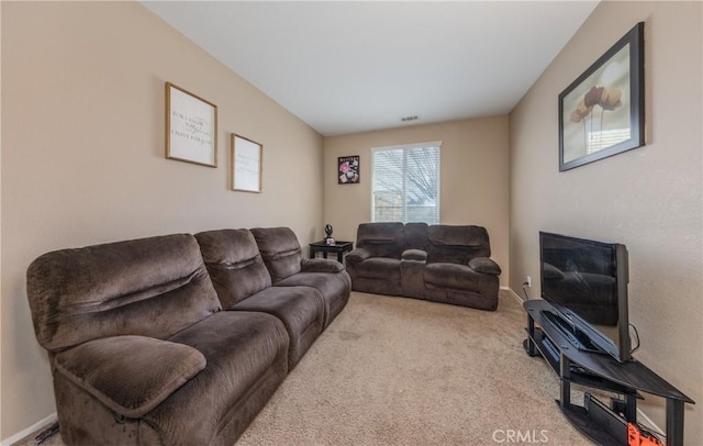 carpeted living room featuring visible vents and baseboards