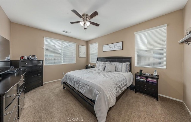 bedroom featuring visible vents, baseboards, ceiling fan, and carpet flooring