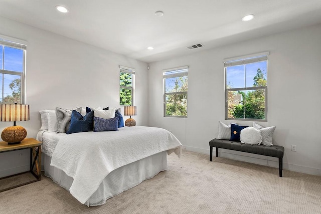 bedroom featuring light carpet, visible vents, recessed lighting, and baseboards