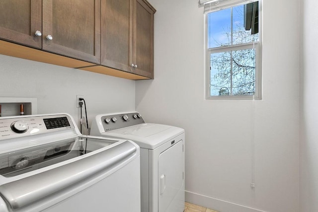 laundry room featuring cabinet space, independent washer and dryer, and baseboards