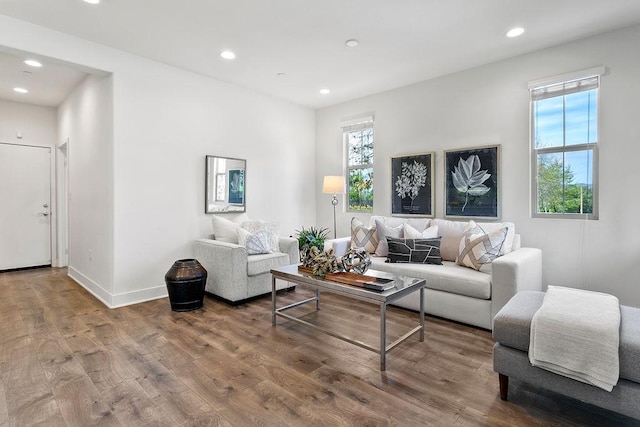 living room featuring recessed lighting, wood finished floors, and baseboards