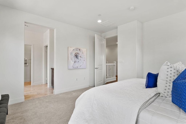 bedroom with recessed lighting, light colored carpet, and baseboards