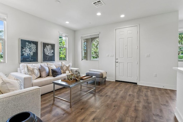 living room with visible vents, recessed lighting, and wood finished floors