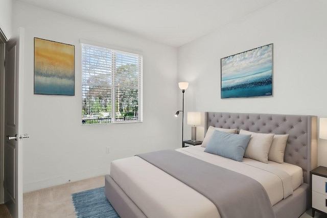 bedroom featuring carpet and baseboards