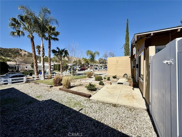 view of yard featuring a mountain view and a patio area