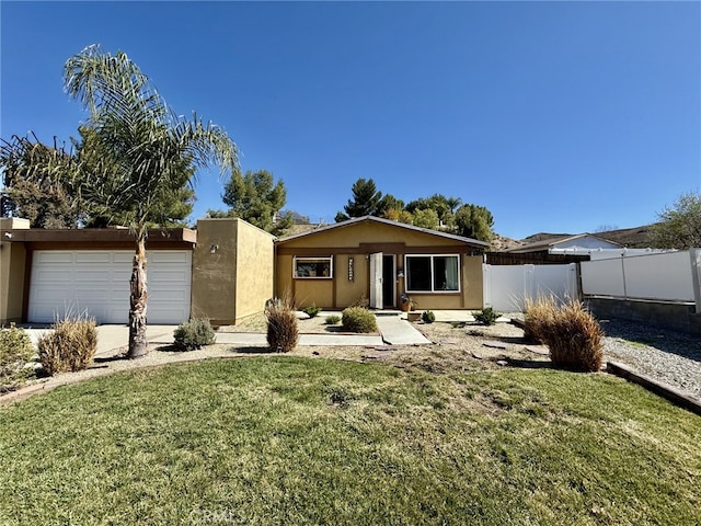 ranch-style house featuring a front lawn, fence, a garage, and stucco siding