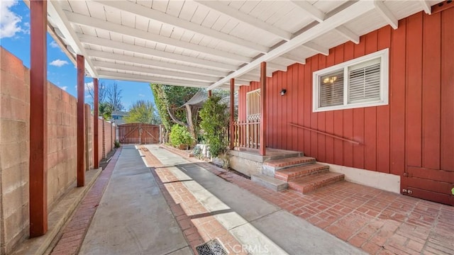 view of patio featuring fence and a gate