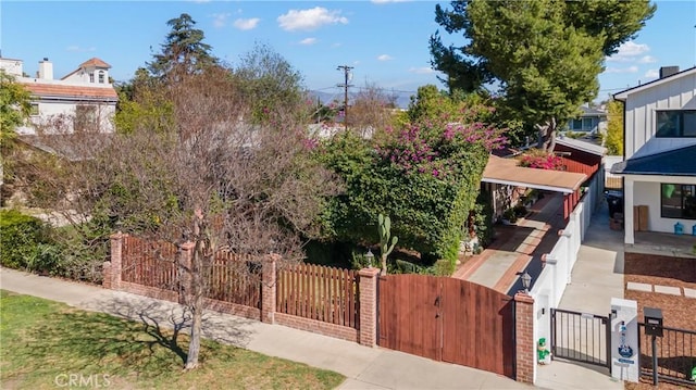 exterior space with a fenced front yard and a gate