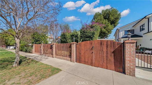 view of gate featuring a fenced front yard