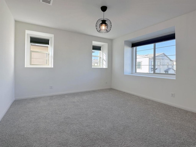 carpeted empty room with baseboards