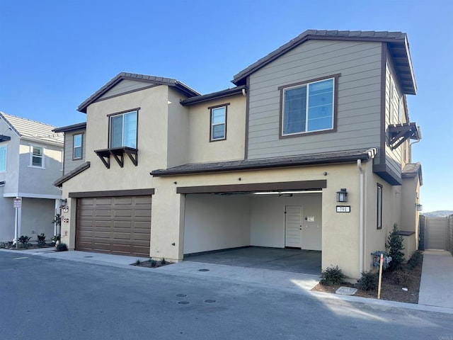 view of front of house with stucco siding and a garage