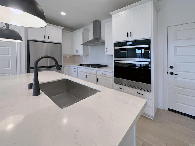 791 Cornelia Way, Rancho Mission Viejo, CA 92694 - kitchen with wall chimney range hood, stainless steel appliances, a sink, white cabinets, and light stone counters