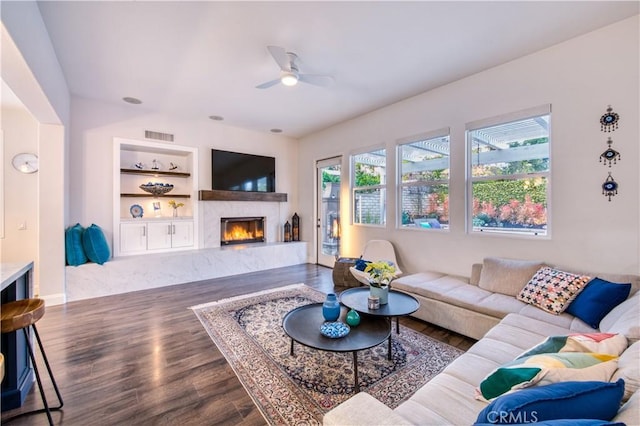 16 Lyra Way, Coto De Caza, CA 92679 - living area with ceiling fan, a fireplace, wood finished floors, built in features, and baseboards