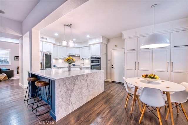 16 Lyra Way, Coto De Caza, CA 92679 - kitchen with appliances with stainless steel finishes, dark wood-style floors, white cabinets, and recessed lighting