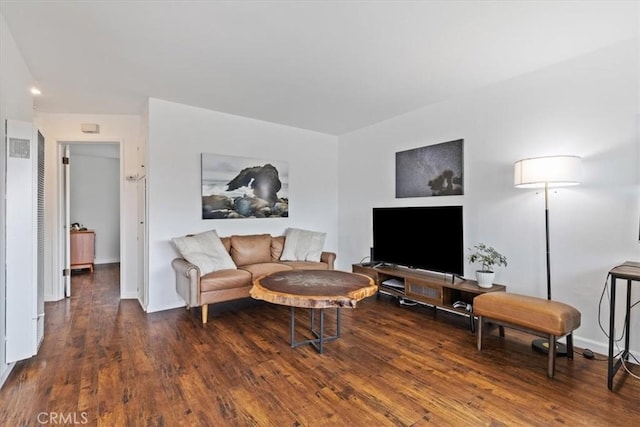 living room featuring baseboards and wood finished floors