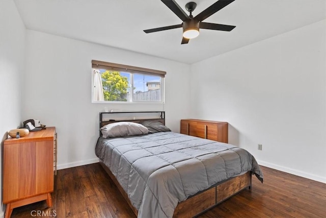 bedroom with ceiling fan, baseboards, and wood finished floors