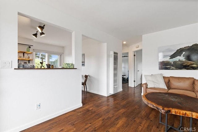 living area featuring baseboards and wood finished floors