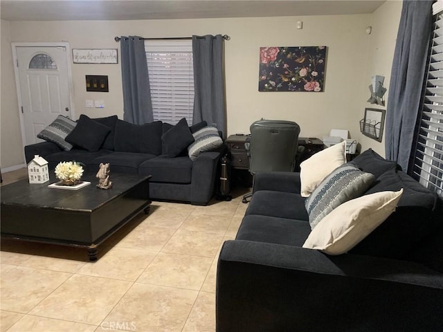 living room with light tile patterned floors and baseboards