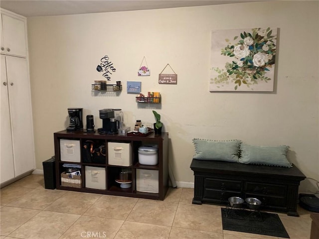 interior space with light tile patterned floors and baseboards