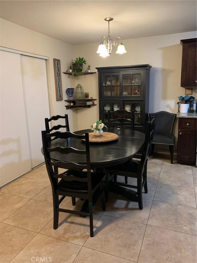 dining area featuring a notable chandelier and light tile patterned floors