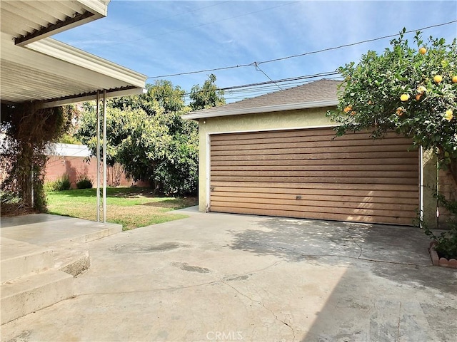 detached garage featuring fence