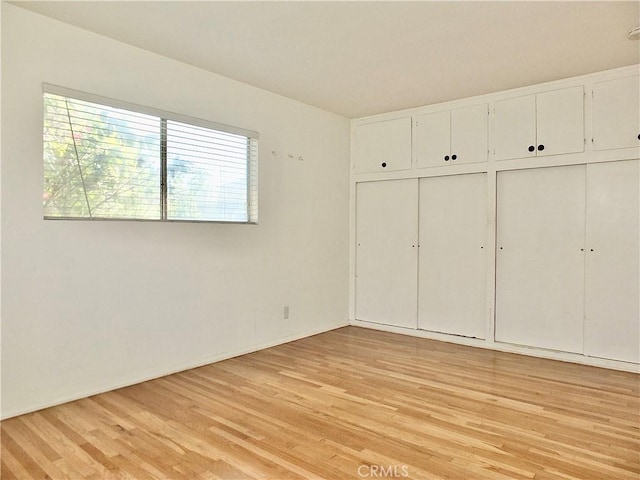 unfurnished bedroom featuring light wood-type flooring