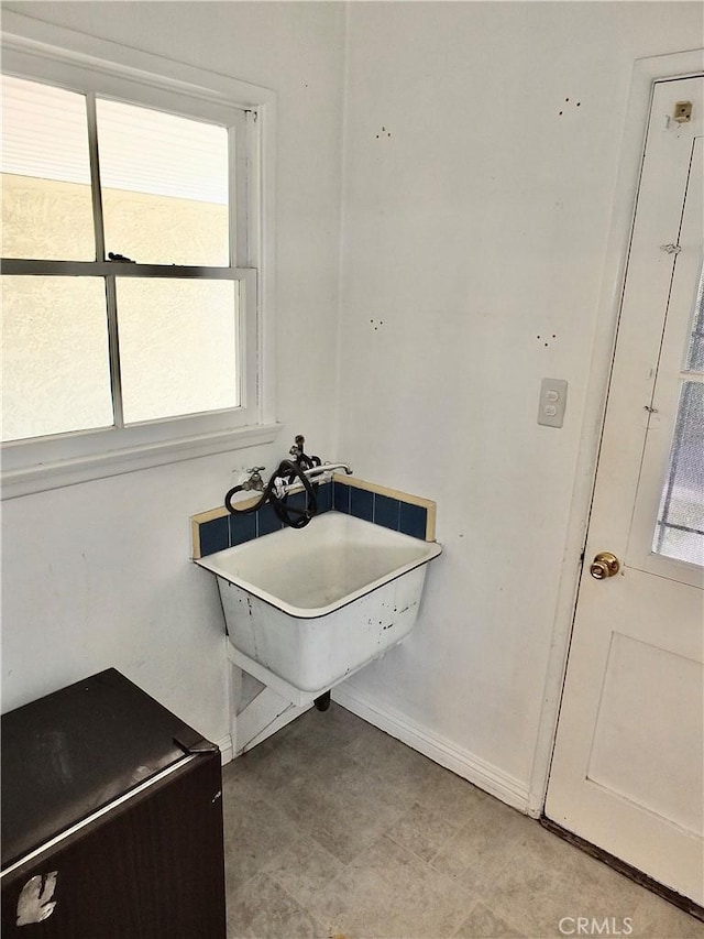 bathroom with baseboards and a sink