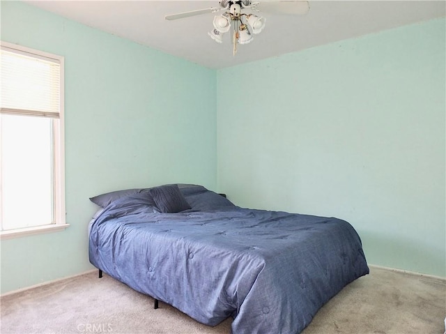 carpeted bedroom with a ceiling fan