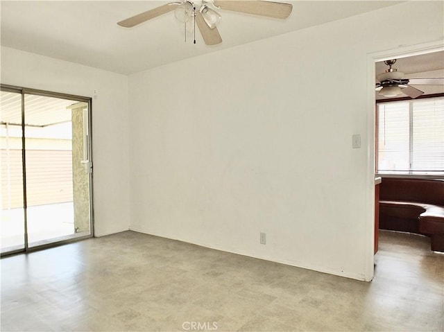 empty room featuring a ceiling fan and a healthy amount of sunlight