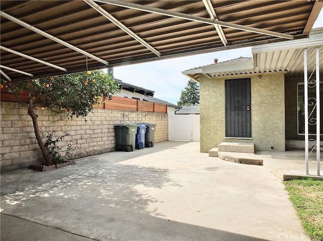 view of patio featuring fence