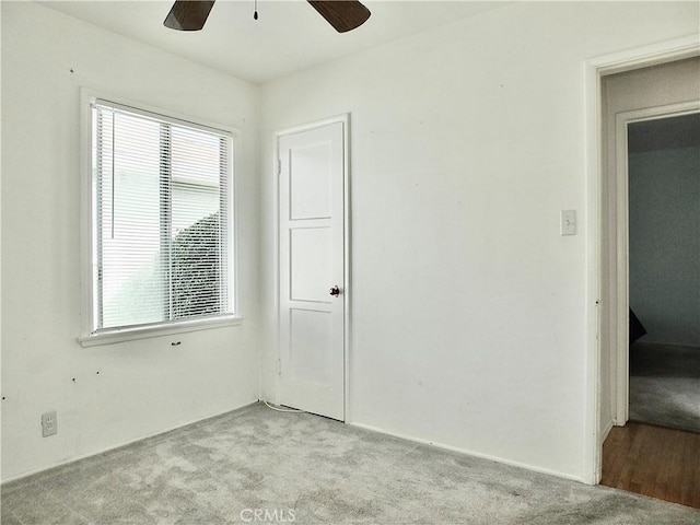 spare room featuring a ceiling fan and light colored carpet