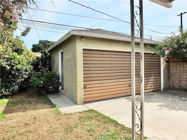 detached garage featuring fence