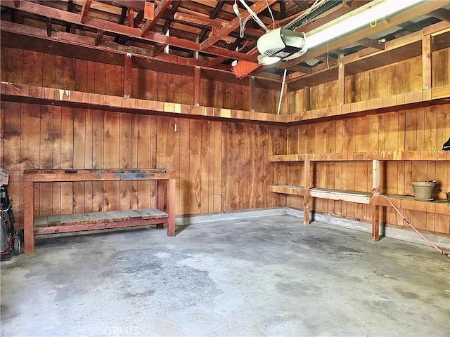 garage featuring wooden walls and a garage door opener