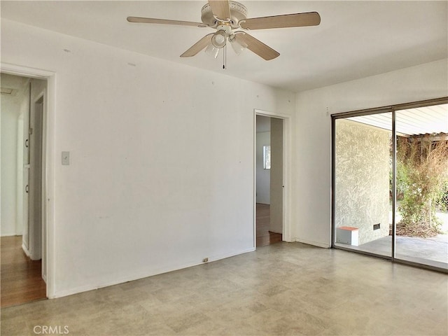 unfurnished room featuring a ceiling fan and baseboards