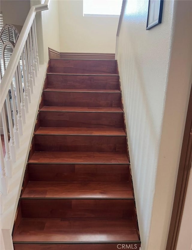 staircase featuring wood finished floors