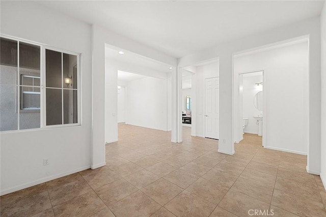 empty room with tile patterned floors and baseboards