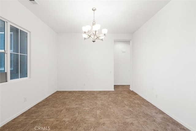 tiled empty room with a notable chandelier, visible vents, and baseboards