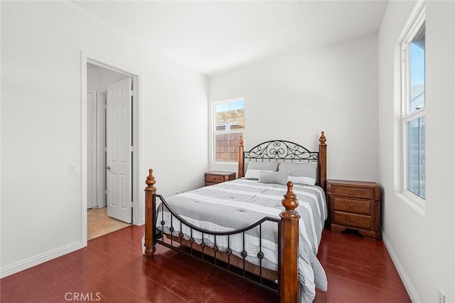 bedroom featuring baseboards and wood finished floors