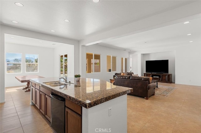 kitchen featuring an island with sink, recessed lighting, a sink, black dishwasher, and open floor plan