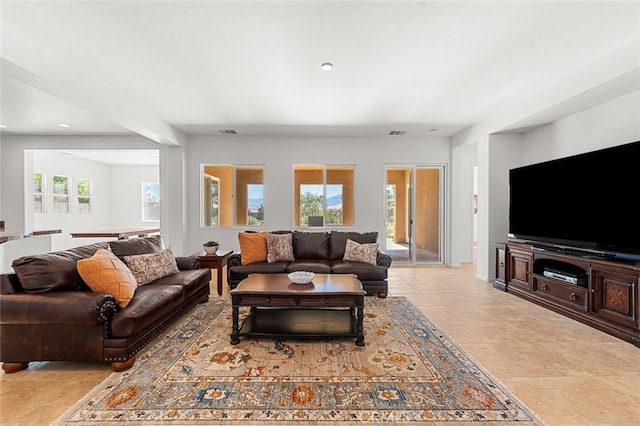 living area featuring light tile patterned floors and visible vents