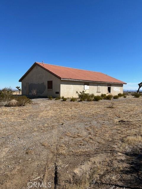 view of side of property featuring stucco siding